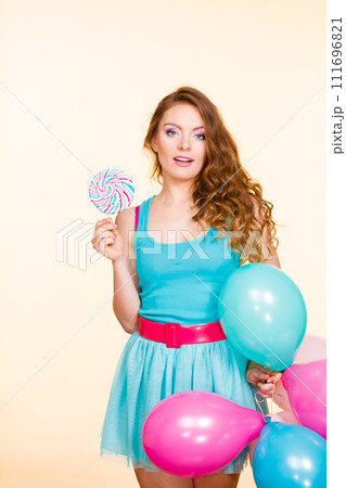 Woman with colorful balloons and lollipop 111696821