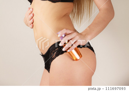 Woman applying moisturizing body oil lotion Woman applying moisturizing body oil lotion 111697093