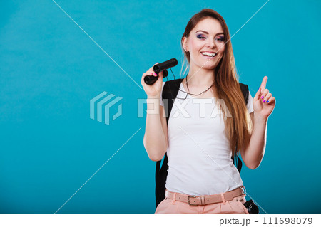 Tourist woman with binoculars on blue Tourist woman with binoculars on blue 111698079