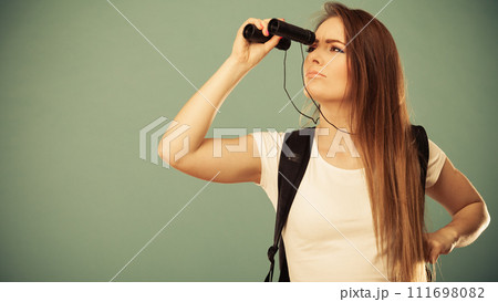 Tourist woman looking through binocular Tourist woman looking through binocular 111698082