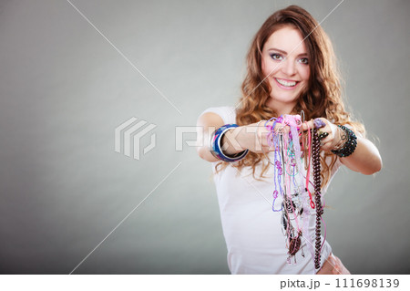 Happy woman with jewelry necklaces ring bracelets 111698139