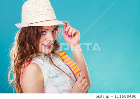 woman in summer hat eating ice pop cream woman in summer hat eating ice pop cream 111698490