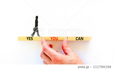 Motivational and Yes you can symbol. Concept words Yes you can on beautiful wooden blocks. Beautiful white background. Businessman hand. Business motivational and Yes you can concept. Copy space. 111700198