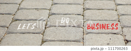 let is do business symbol. Concept words let is do business on beautiful grey paving slabs. Beautiful grey paving slabs background. let is do business concept. Copy space. 111700263