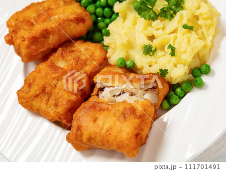 fried fish with mashed potatoes and green peas fried fish with mashed potatoes and green peas 111701491