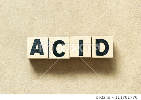 Alphabet letter block in word acid on wood background Alphabet letter block in word acid on wood background 111701770