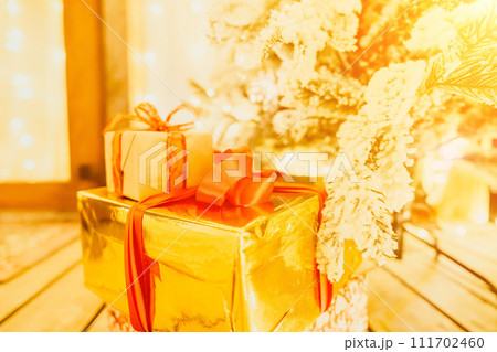 presents under Christmas tree, festive and celebratory atmosphere. 111702460
