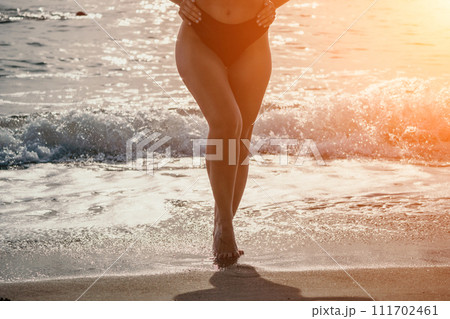 Woman summer travel sea. Happy woman enjoying her summer travels, captured in a lower body portrait, taking photos to preserve her memories of the scenic sea beach sharing travel adventure journey Woman summer travel sea. Happy woman enjoying her summer travels, captured in a lower body portrait, taking photos to preserve her memories of the scenic sea beach sharing travel adventure journey 111702461