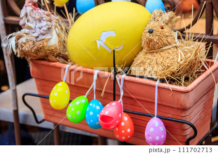 Easter decoration with Easter eggs and Easter bunny in a pot Easter decoration with Easter eggs and Easter bunny in a pot 111702713