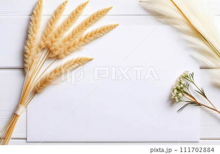 Blank empty cardstock sheet Invitation without text, invitation mockup. Dry pampas, flowers, white desk. Flat lay, top view. Soft paper card floral mock up. Modern Minimal business brand template. A4 111702884