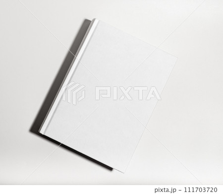 Blank book cover mockup. Clear textbook hardback, catalog lying on table 111703720