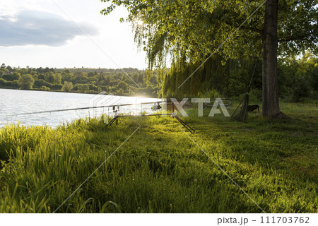 Fishing adventures. Carp fishing at sunset. 111703762