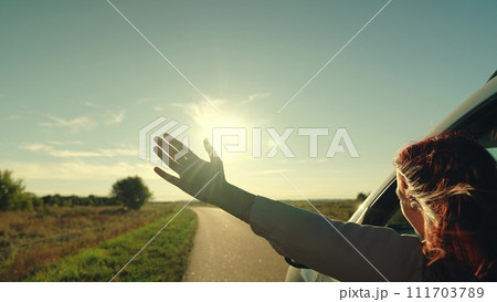 girl rides car with her hand out window, driver hand, girl waving her hand from car window, movement driver hand from window, happy family enjoying having fun together, conceptual car journey along girl rides car with her hand out window, driver hand, girl waving her hand from car window, movement driver hand from window, happy family enjoying having fun together, conceptual car journey along 111703789