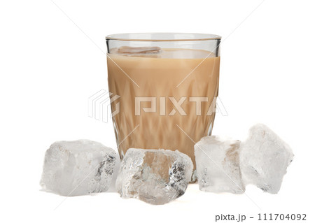 Close-up of a glass with Irish cream liqueur with ice and ice cubes on a white background. Close-up of a glass with Irish cream liqueur with ice and ice cubes on a white background. 111704092