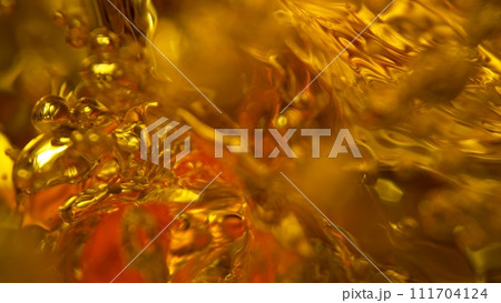 Freeze Motion Shot of Whiskey Liquid Pouring, Macro, Unique Angle of View from the Bottom of the Glass Freeze Motion Shot of Whiskey Liquid Pouring, Macro, Unique Angle of View from the Bottom of the Glass 111704124