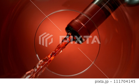 Freeze Motion Shot of Red Wine Pouring, Unique Angle of View from the Bottom of the Glass Freeze Motion Shot of Red Wine Pouring, Unique Angle of View from the Bottom of the Glass 111704145