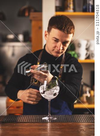 Barman making an alcoholic drink Barman making an alcoholic drink 111704818
