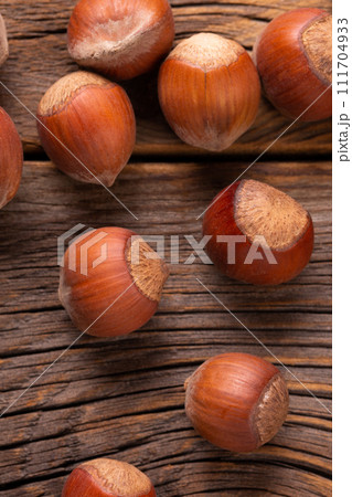 Hazelnuts in shell close-up. 111704933