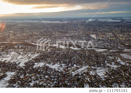 Top view of city suburbs or small town nice houses on winter morning on cloudy sky background. Aerial drone photography concept. 111705181