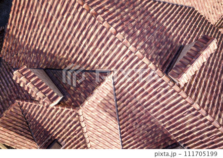 Top aerial view of building complex shingle roof construction. Abstract background. Top aerial view of building complex shingle roof construction. Abstract background. 111705199