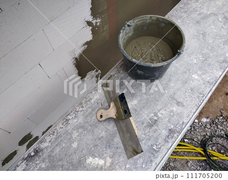 Tools and material foe covering walls with protective adhesive before finish paint. Tools and material foe covering walls with protective adhesive before finish paint. 111705200