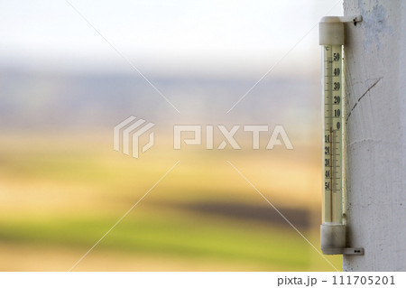Thermometer celsius showing cold temperature on blurred background. Weather forecast concept. Thermometer celsius showing cold temperature on blurred background. Weather forecast concept. 111705201