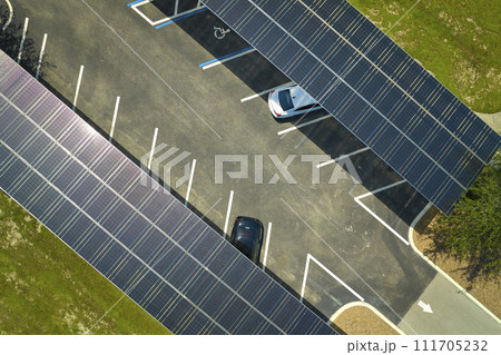 Solar panels installed over parking lot for parked cars for effective generation of clean energy 111705232