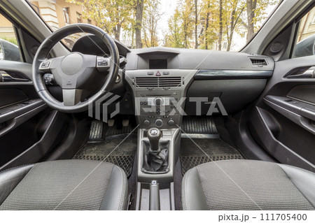 Luxurious car interior. Dashboard, steering wheel, gearshift and comfortable seats. Transportation, design, modern technology concept. Luxurious car interior. Dashboard, steering wheel, gearshift and comfortable seats. Transportation, design, modern technology concept. 111705400