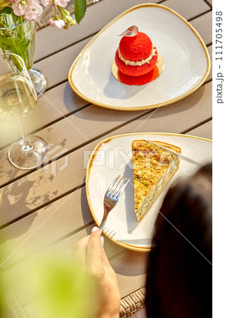 Delightful al fresco lunch with pie, dessert and glass of white 111705498