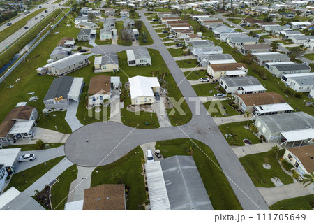 Consequences of natural disaster in southern Florida after hurricane season. Severely damaged houses in mobile home residential area Consequences of natural disaster in southern Florida after hurricane season. Severely damaged houses in mobile home residential area 111705649