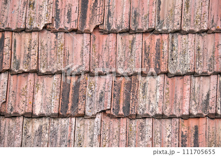 Closeup surface of old weathered ceramic tiles covering building roof Closeup surface of old weathered ceramic tiles covering building roof 111705655