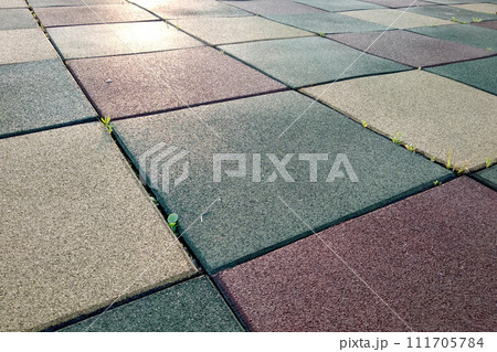 Close up of soft rubber tiles for covering at outdoor gym of stadium at preschool yard. 111705784
