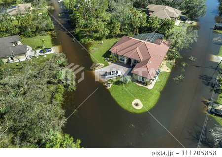 Aftermath of natural disaster. Flooded houses by hurricane Ian rainfall in Florida residential area Aftermath of natural disaster. Flooded houses by hurricane Ian rainfall in Florida residential area 111705858