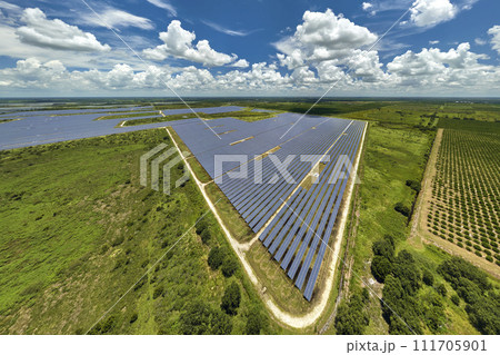 Aerial view of sustainable electric power plant between agricultural farm fields with solar photovoltaic panels for producing clean electrical energy. Renewable electricity with zero emission concept 111705901