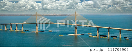Aerial view of Sunshine Skyway Bridge over Tampa Bay in Florida with moving traffic. Concept of transportation infrastructure Aerial view of Sunshine Skyway Bridge over Tampa Bay in Florida with moving traffic. Concept of transportation infrastructure 111705903