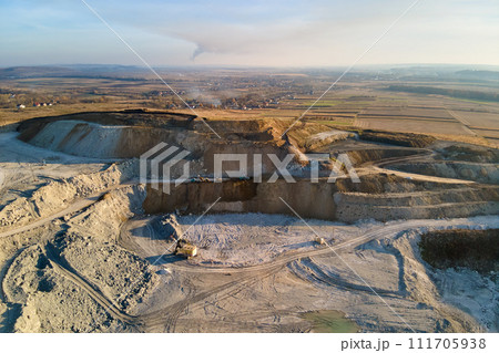 Aerial view of open pit mine of sandstone materials for construction industry with excavators and dump trucks. Heavy equipment in mining and production of useful minerals concept 111705938