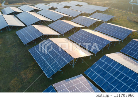 Aerial view of large sustainable electrical power plant with rows of solar photovoltaic panels for producing clean ecological electric energy. Renewable electricity with zero emission concept. 111705960