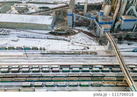 Aerial view of cargo train loaded with crushed stone materials at mining factory. Railway transportation of grinded limestone ore Aerial view of cargo train loaded with crushed stone materials at mining factory. Railway transportation of grinded limestone ore 111706018