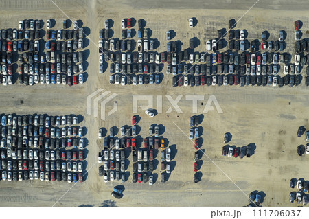 Aerial view of auction reseller company big parking lot with parked cars ready for remarketing services. Sales of secondhand vehicles Aerial view of auction reseller company big parking lot with parked cars ready for remarketing services. Sales of secondhand vehicles 111706037