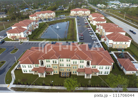 Aerial view of american apartment buildings in Florida residential area. New family condos as example of housing development in US suburbs 111706044