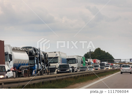 Queue of Trucks on Ukraine-Poland Border traffic jam at Sunset During Protest Roadblock. Business agricultural Logistics blockade action. Cargo lorry semi-trailers stuck 111706084