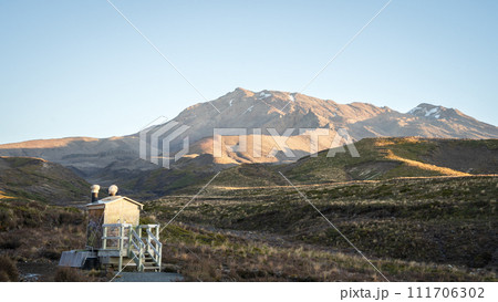 Toilet on the side of hiking track with beautiful mountainous landscape surrounding it, New Zealand Toilet on the side of hiking track with beautiful mountainous landscape surrounding it, New Zealand 111706302