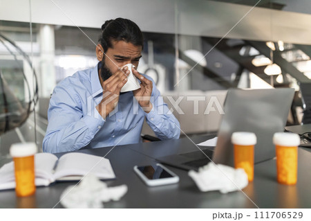 Sick Millennial Hindu Businessman Working From Office Sick Millennial Hindu Businessman Working From Office 111706529