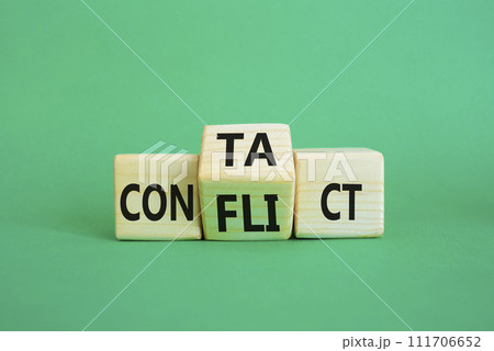 Contact and Conflict symbol. Wooden cubes with words Contact and Conflict. Beautiful green background. Contact and Conflict and business concept. Copy space 111706652