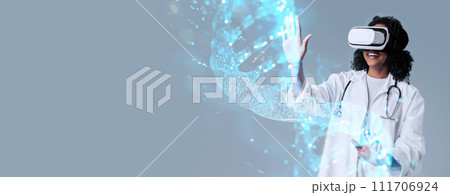 Excited black woman doctor in VR glasses touching DNA chain 111706924