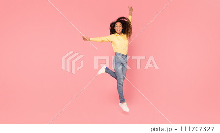 Elegant black lady posing against pink backdrop Elegant black lady posing against pink backdrop 111707327