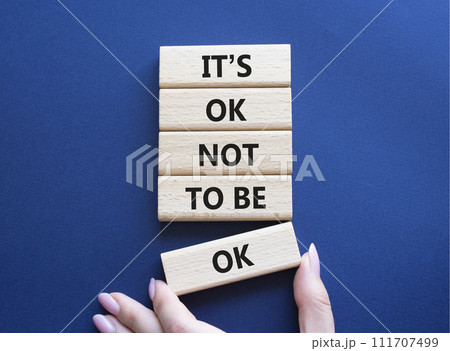 Mental Health symbol. Wooden blocks with words It is ok not to be ok. Doctor hand. Beautiful deep blue background. Mental Health concept. Copy space. 111707499