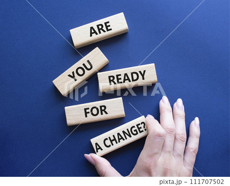 Change symbol. Wooden blocks with words Are you ready for a new change. Businessman hand. Beautiful deep blue background. Business and change concept. Copy space. 111707502