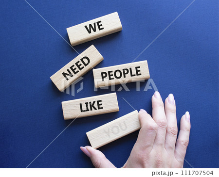 Hiring symbol. Wooden blocks with words We need People like You. Businessman hand. Beautiful deep blue background. Business and Hiring concept. Copy space. 111707504