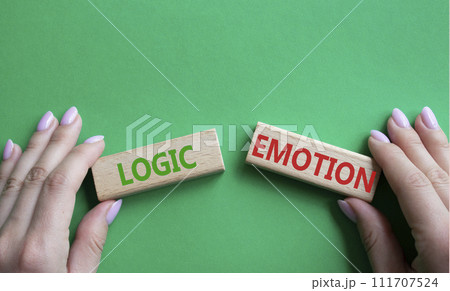 Logic or Emotion symbol. Concept word Logic or Emotion on wooden blocks. Businessman hand. Beautiful green background. Business and Logic or Emotion concept. Copy space Logic or Emotion symbol. Concept word Logic or Emotion on wooden blocks. Businessman hand. Beautiful green background. Business and Logic or Emotion concept. Copy space 111707524